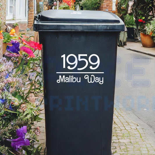 Personalised Malibu style wheelie bin sticker showing house number and street name in stylish script on a bin outside a UK home by Pixel Printworks