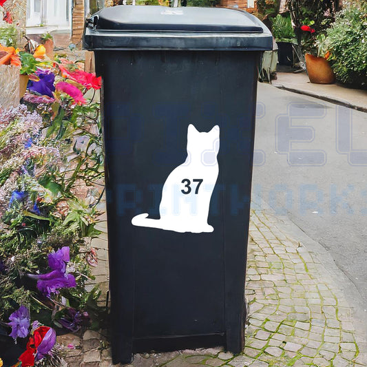 Personalised cat wheelie bin sticker showing a cat silhouette with house number on a bin outside a UK home by Pixel Printworks