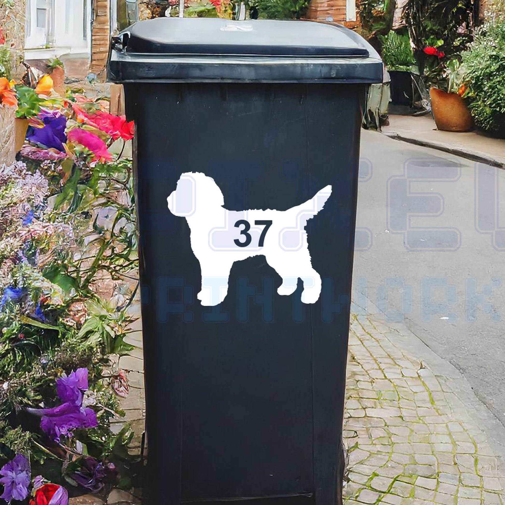 Personalised Cockapoo wheelie bin sticker showing a fluffy Cockapoo silhouette with cut-out house number on a bin outside a UK home by Pixel Printworks