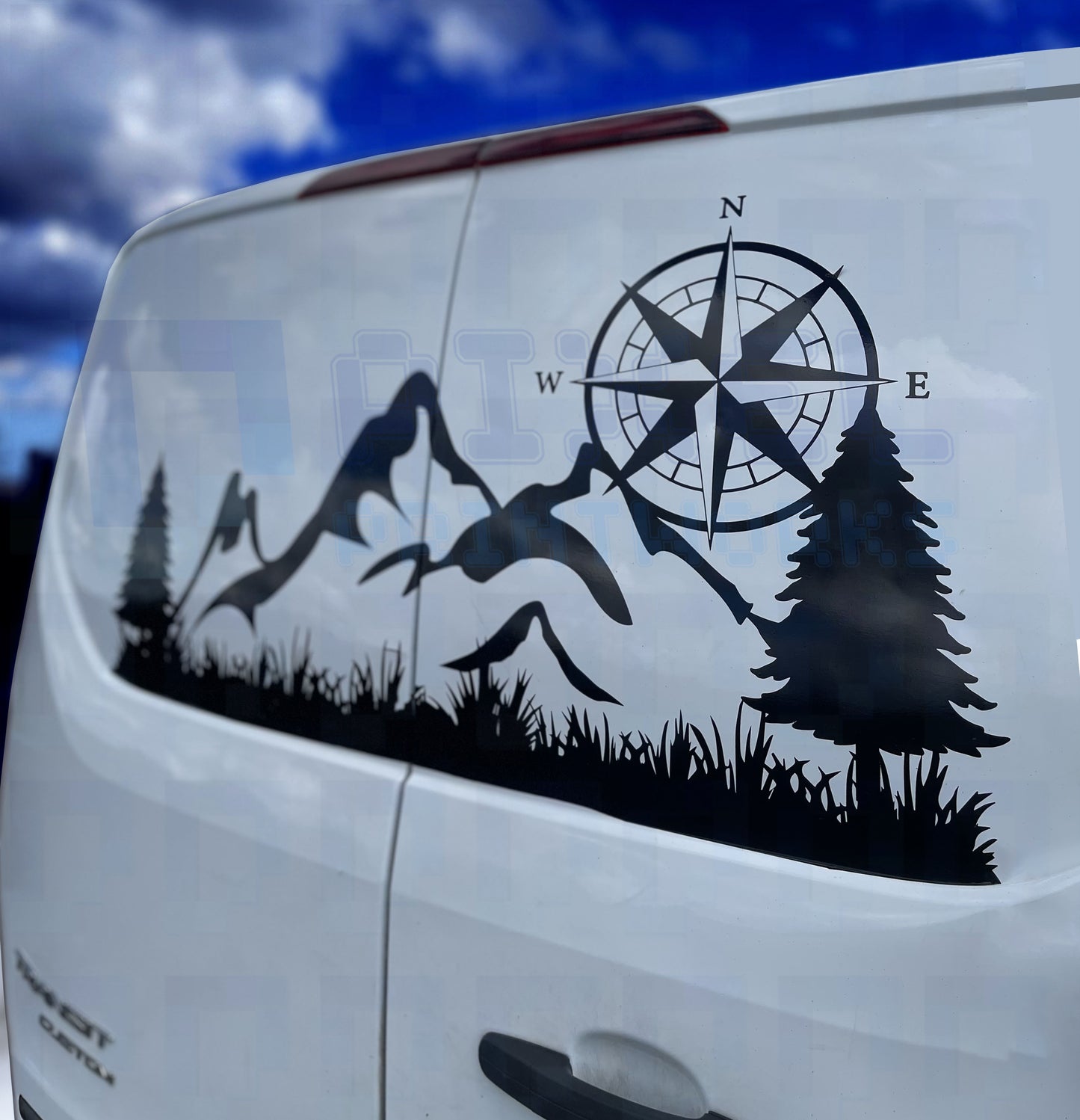Mountain and compass vinyl decal on the rear window of a camper van by Pixel Printworks