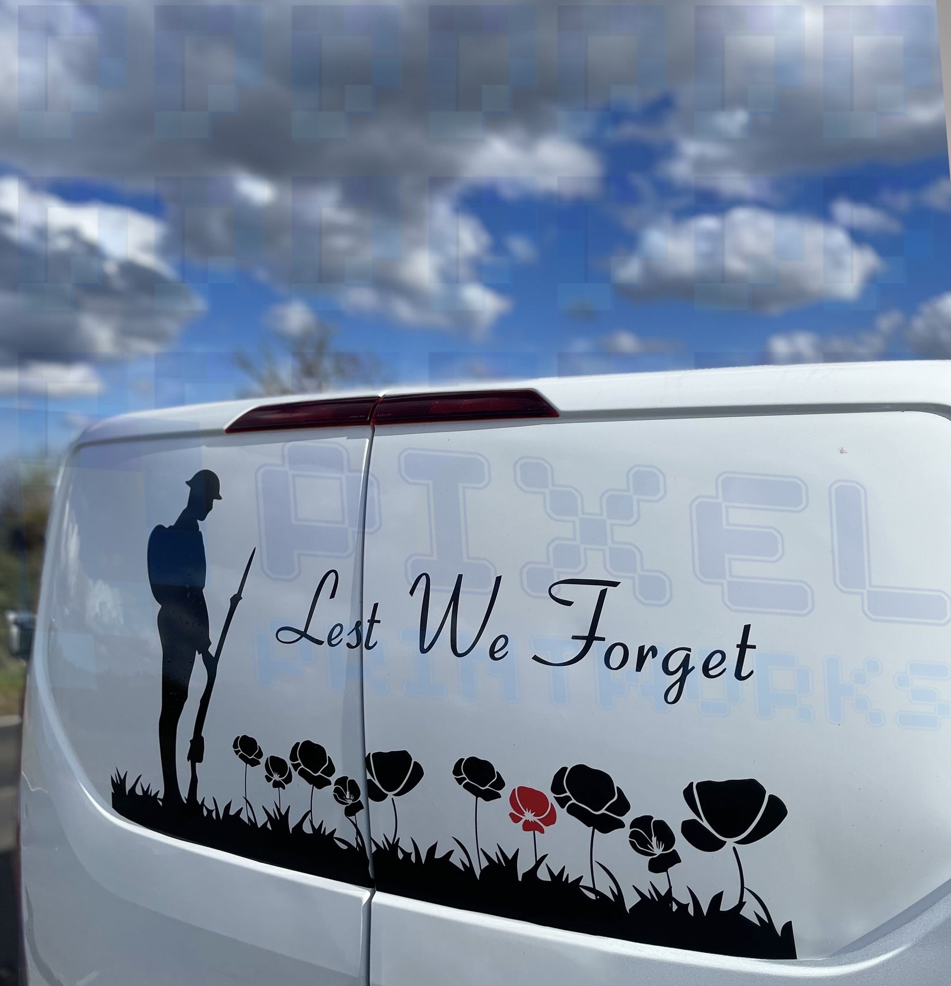 Lest We Forget poppy field vinyl decal with WW1 soldier on back of grey van