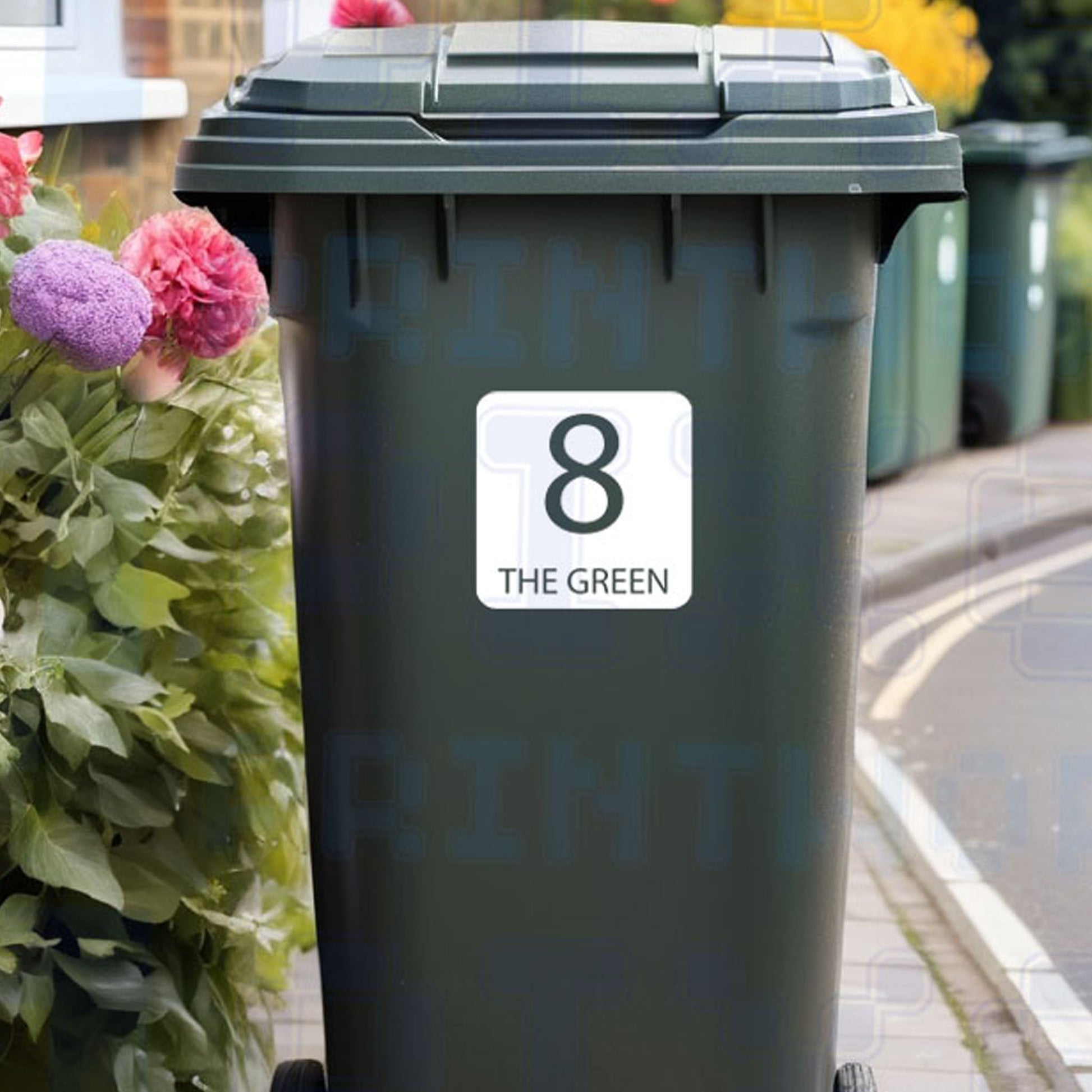Personalised square wheelie bin sticker showing bold house number and street name inside a square border on a bin outside a UK home by Pixel Printworks