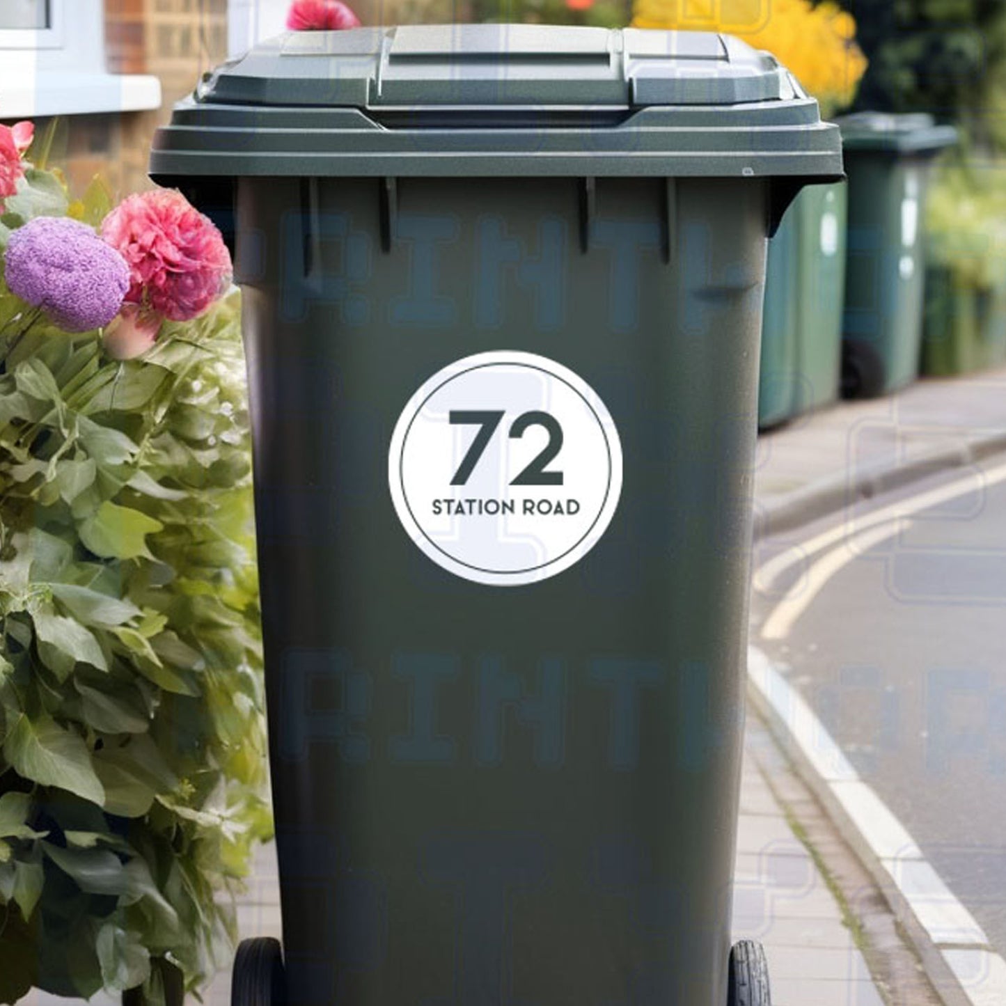 Personalised circle wheelie bin sticker showing house number and street name inside a bold circular border on a bin outside a UK home by Pixel Printworks