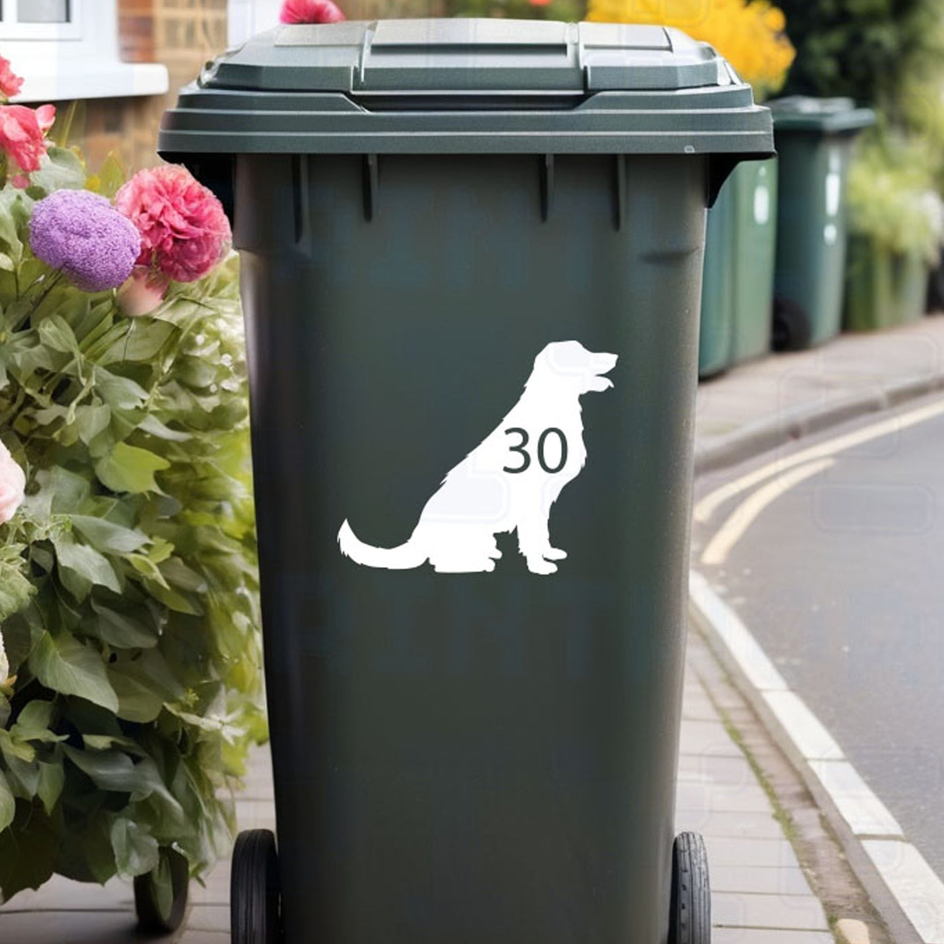 Personalised Labrador wheelie bin sticker showing sitting Labrador silhouette with cut-out house number on a bin outside a UK home by Pixel Printworks