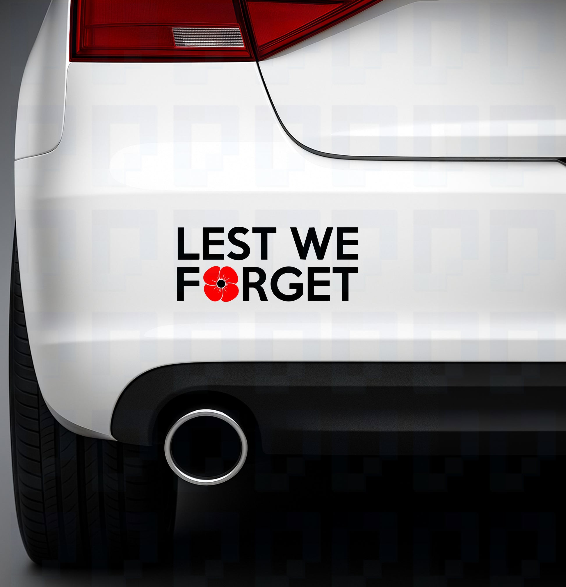 Lest We Forget bumper sticker with red poppy applied to the rear of a white car near the exhaust