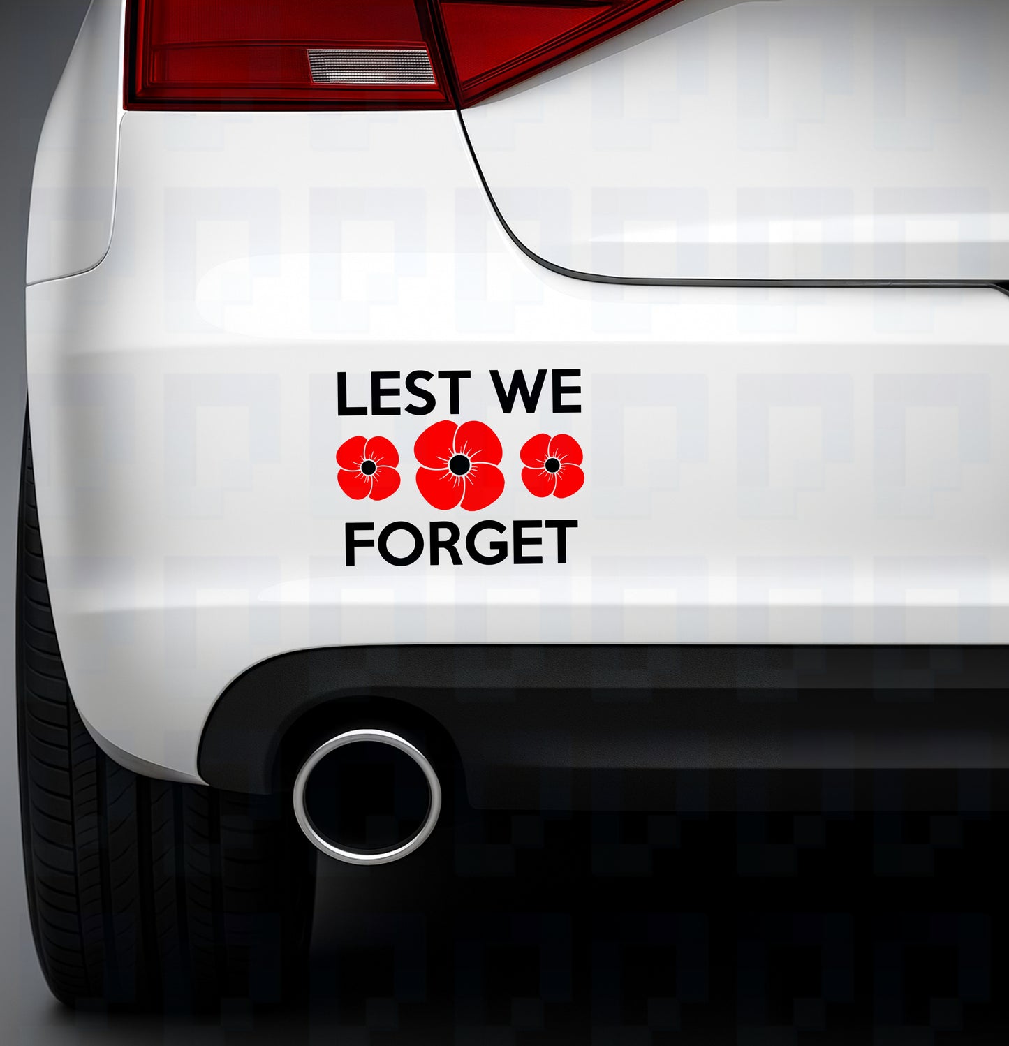 Lest We Forget bumper sticker with three red poppies replacing the “O”, applied to the rear of a white car