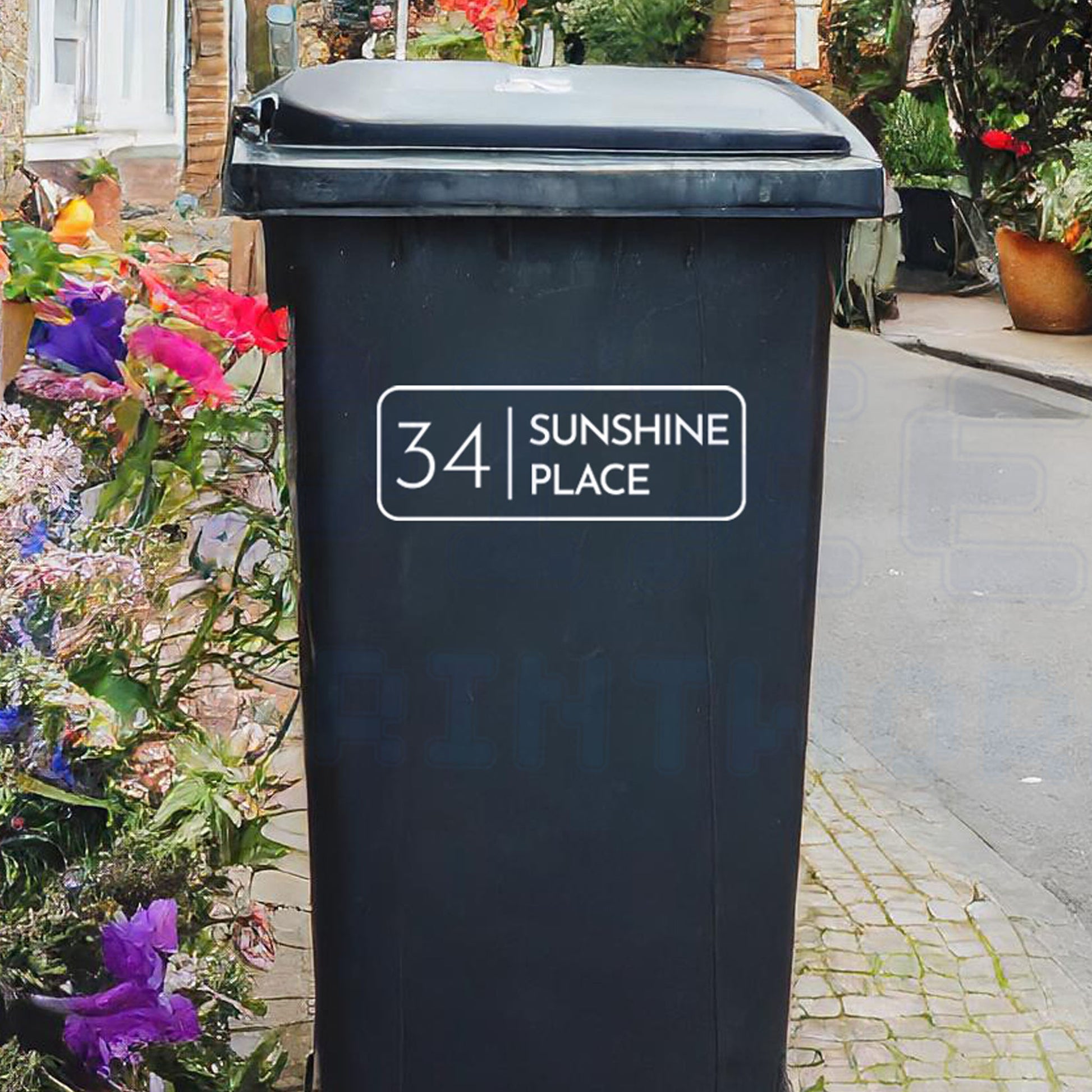 Personalised classic rectangle wheelie bin sticker showing house number and street name in a framed design on a bin outside a UK home by Pixel Printworks