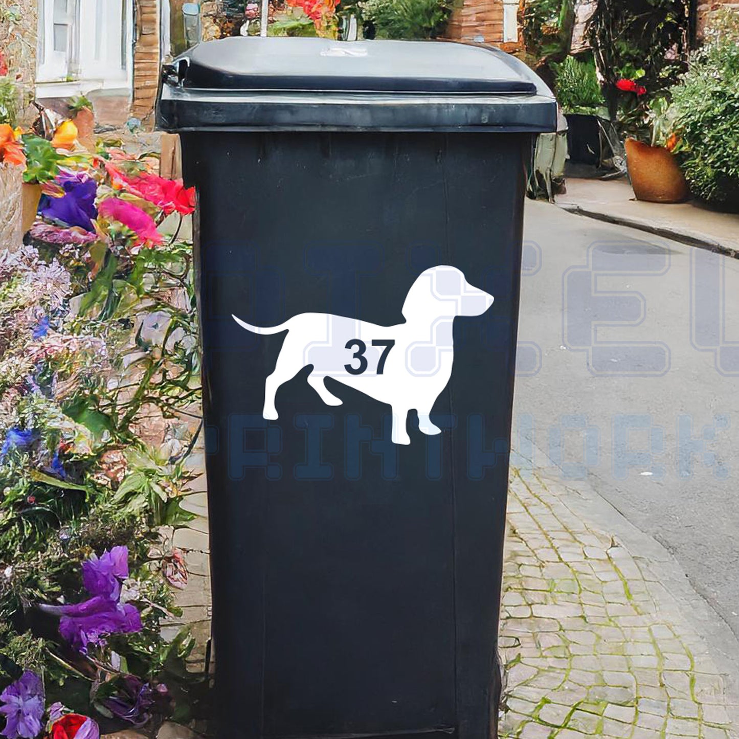 Personalised sausage dog wheelie bin sticker showing a dachshund silhouette with cut-out house number on a bin outside a UK home by Pixel Printworks