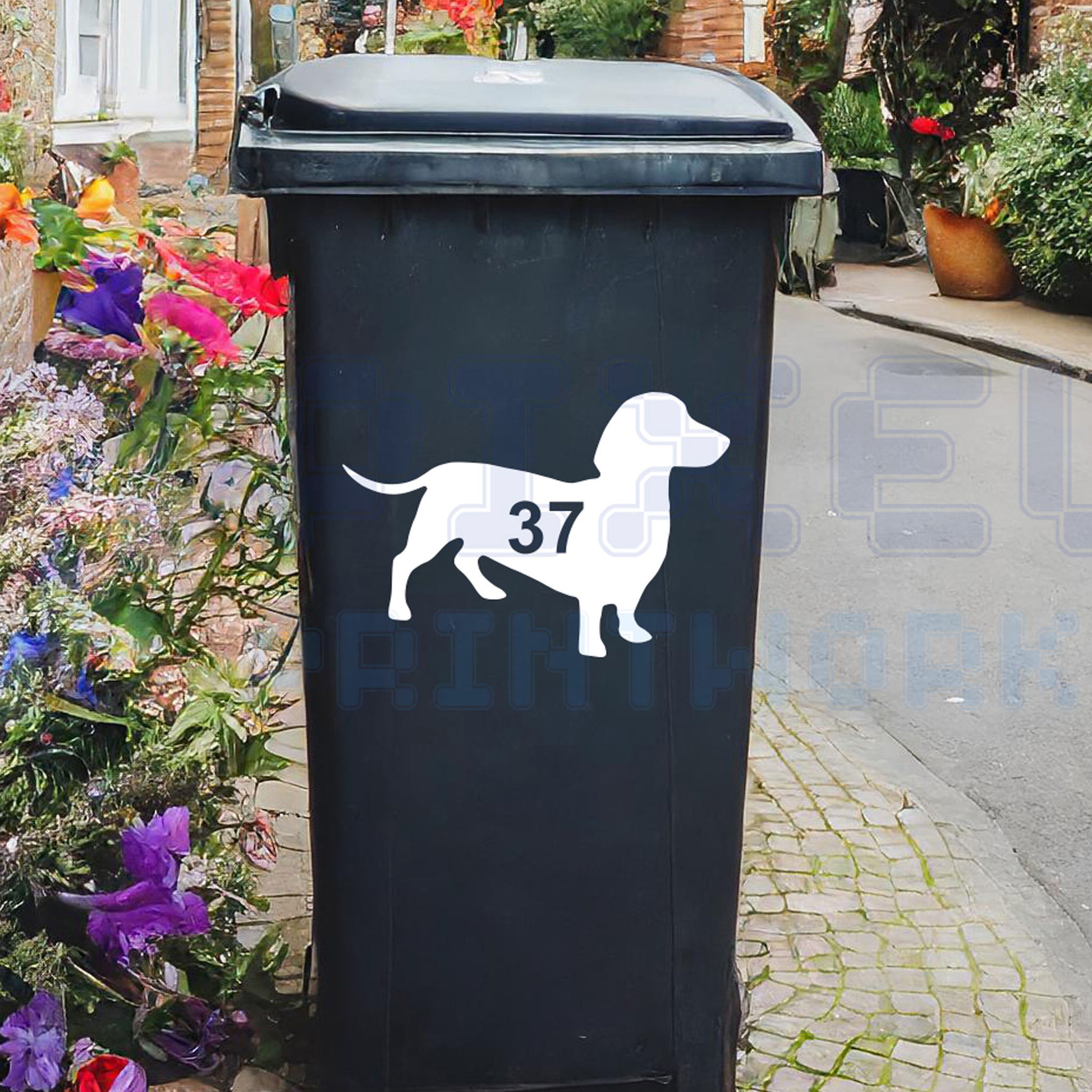 Personalised sausage dog wheelie bin sticker showing a dachshund silhouette with cut-out house number on a bin outside a UK home by Pixel Printworks